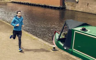 A man running along a canal