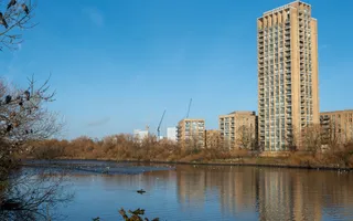 Clear sky with skyscaper in the background. Reservoir in the foreground