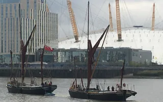 Two Thames barges leaving West India Dock