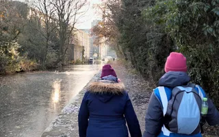 Two people walking on a towpath on a winters day