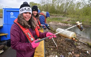 People litter picking smiling to camera
