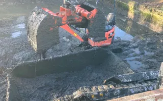 Digger in a canal removing silt