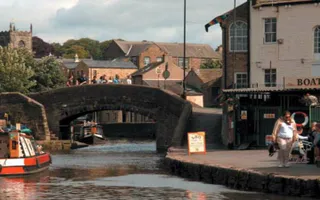 Boats on Leeds & Liverpool Canal in Skipton with people on the towpaths