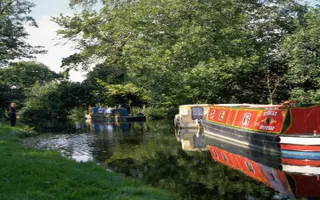 Boats on Chesterfield Canal, with people on grassy towpath