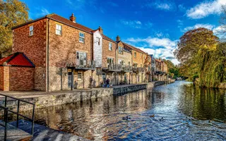 Row of buildings along a canal on a sunny day