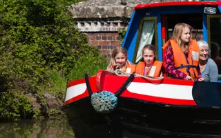 A family taking a boat holiday on the Grand Union Canal