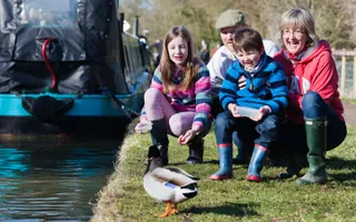 A family feeding a duck