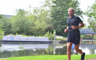 Man running along the canal