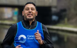 Man smiles as he runs in Canalathon 2023