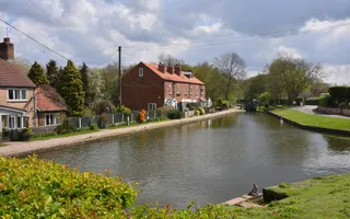wide shot of a canal with canalside houses on a cloudy day