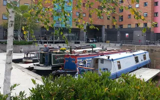 Boats  moored in Loughborough Basin surrounded by colourful high-rise buildings
