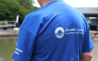 Man wearing a blue t shirt with Canal & River Trust logo