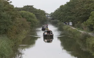 Boats traveling down Slough Arm, family walking on towpath