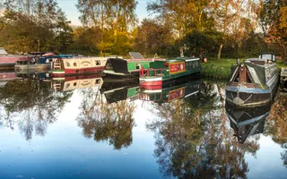 Boats moored with the sun reflecting on the water