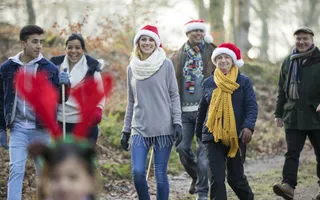 Group of people walking and wearing Santa hats