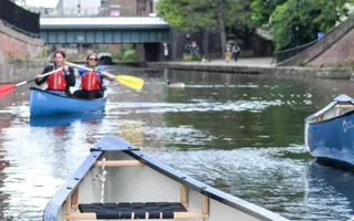two people canoeing on river