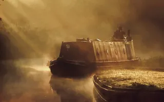 Boater driver boat through mornng mist