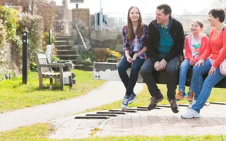 A family sitting on a lock beam
