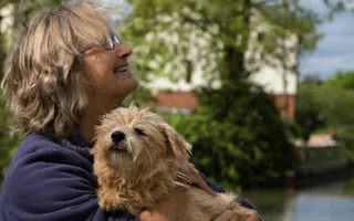 Profile of lady with small brown dog