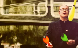 Man juggling by the waterway