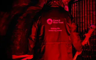 dark picture of a person being lit up with a red light