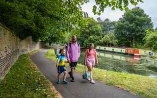 Father and two children walking on a towpath