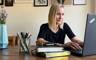 Woman looking at laptop screen while working from home