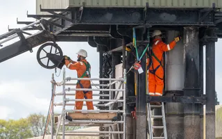 Workers in harnesses