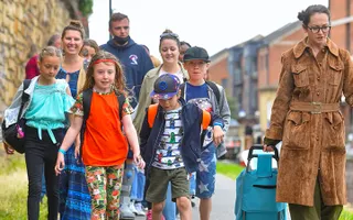 A small group of people take a walk by the canal