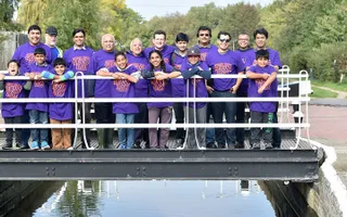 Volunteers pose on a swing bride at Fenny Stratford on the Grand Union Canal