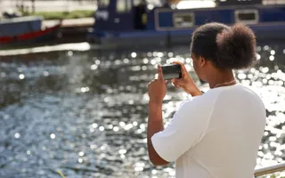 Man taking picture of canal
