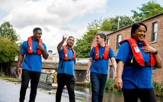 Colleagues in life jackets walking by the canal