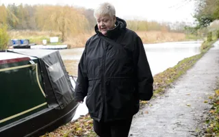 Woman walking along towpath