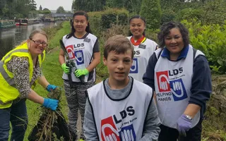 Volunteers holding gardening equipment at Battyeford