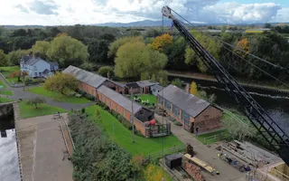 Ariel shot of a brick building with crane in the foreground