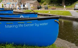 Canoes lined up on towpath, opposite Standedge Tunnel