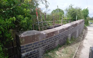 Wide shot of a repaired bridge brick wall