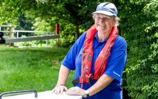 Woman wearing a blue cap and t shirt smiling
