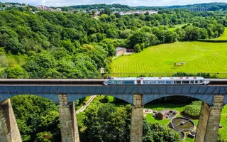 Ariel shot of a narrowboat travelling on an tall aqueduct
