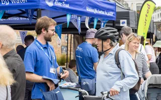 Volunteer talking to passer-by at community event