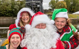 Santa Cruise Christmas 2022 campaign image (Santa, Mrs Claus and elves in front of lift).