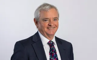 Picture of a man in a suit smiling at camera