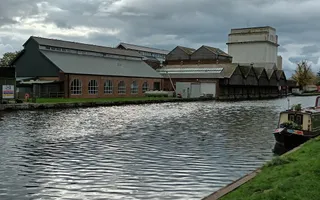 Canal in the foreground with old factory in the background
