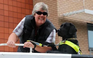 Guide dog Oakley gives Tracey a helping paw at the lock
