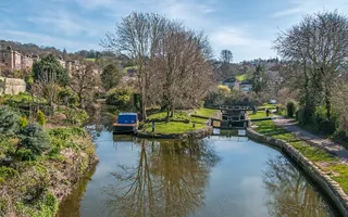 Landscape image of a sunny day in Bath. Image shows a set of locks.