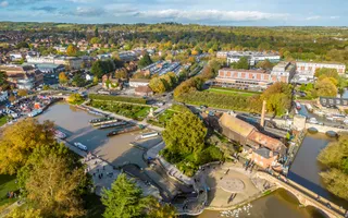 Drone image of Stratford upon avon from above, showing lush green area by canal