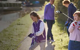 A young family collecting litter on the towpath