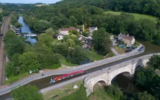 Aerial view of Avoncliff Aqueduct, narrowboats seen travelling across the bridge