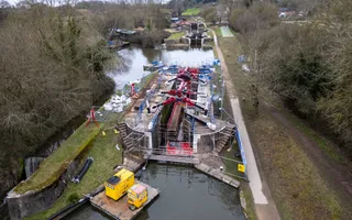 drone shot of a lock gate being repaired wit lots of fencing and crane in the middle