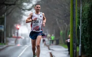 Man running along a tree-lined street